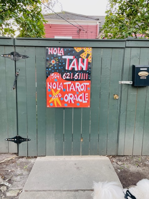 The green gate on Magazine Street with the hand-painted Nola Tarot and Oracle sign